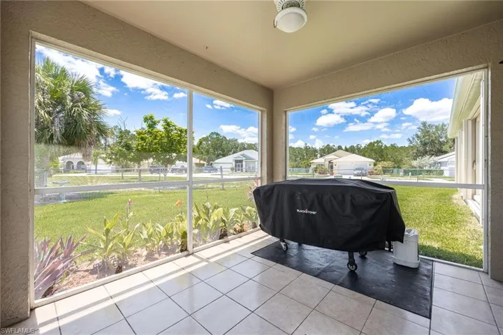 Screened patio featuring tile flooring and a ceiling-mounted light fixture