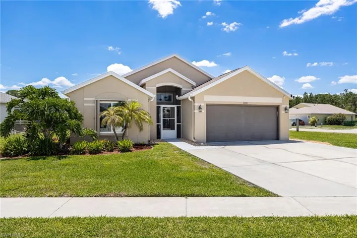 Modern stucco exterior with an arched entryway and covered porch