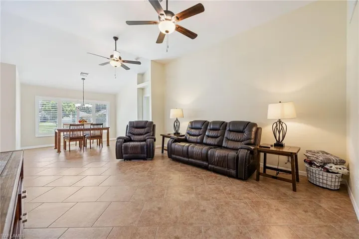 Vaulted ceilings featuring two ceiling fans with integrated lighting