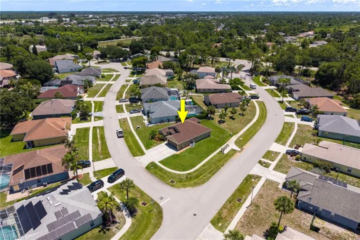 Residential neighborhood featuring varied single-story homes with shingled roofs and private driveways