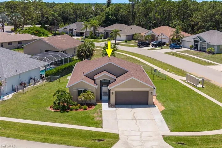Single-story residence featuring a brown shingle roof, attached two-car garage, and a concrete driveway