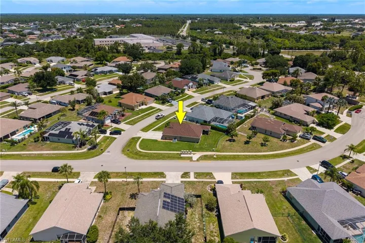 Residential property situated within a developed neighborhood featuring paved streets and manicured lawns