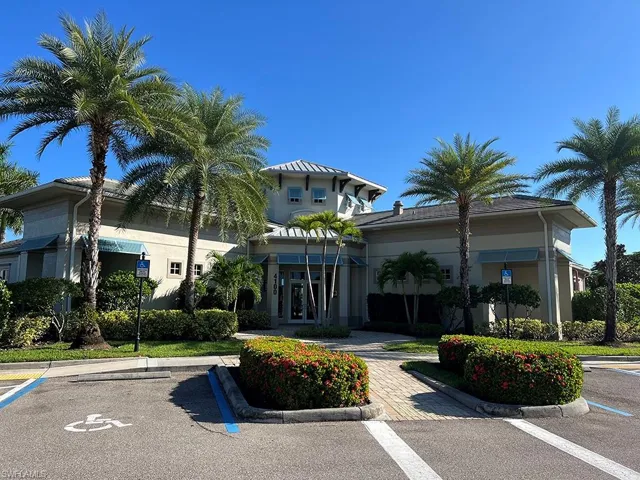 View of building exterior with uncovered parking