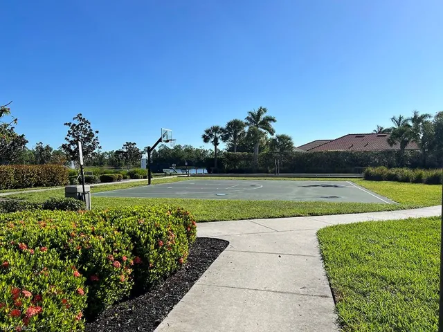 View of sport court featuring a lawn and community basketball court