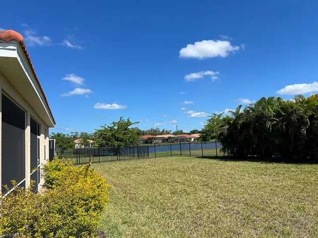 Fenced backyard featuring a water view