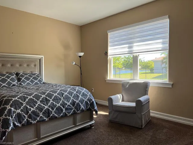 Carpeted bedroom featuring baseboards