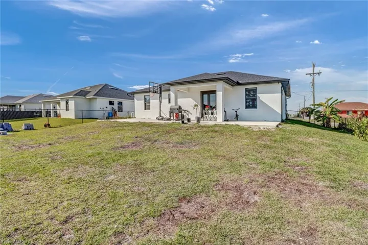 Rear view of property featuring a patio area and a yard