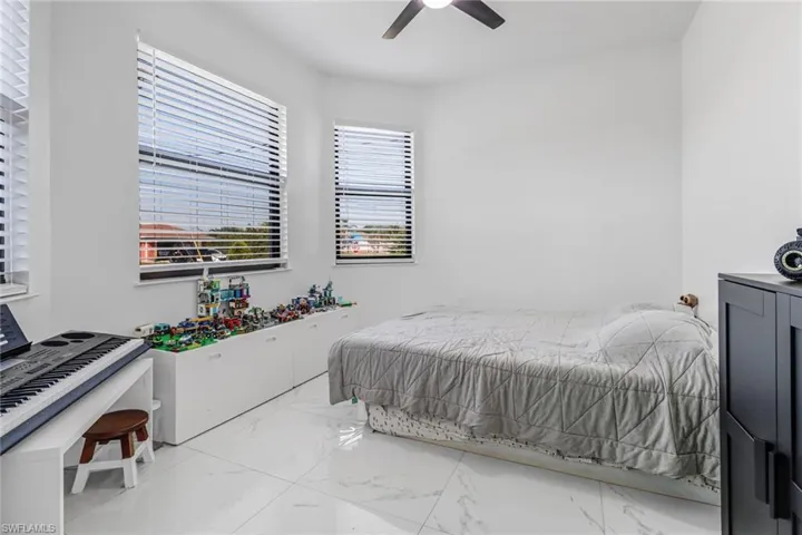 Tiled bedroom with ceiling fan