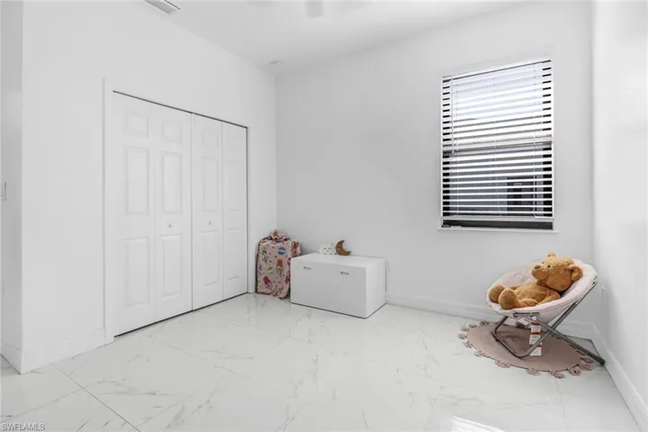 Unfurnished bedroom with light tile patterned flooring and a closet