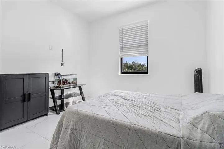 Bedroom with light tile patterned floors