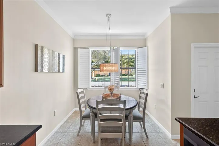 Dining room with crown molding and baseboards