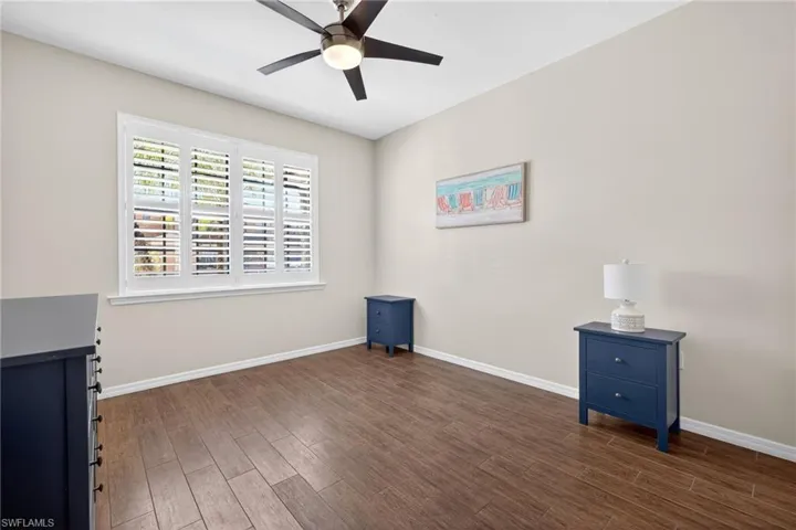 Spare room with dark wood-style flooring and a ceiling fan