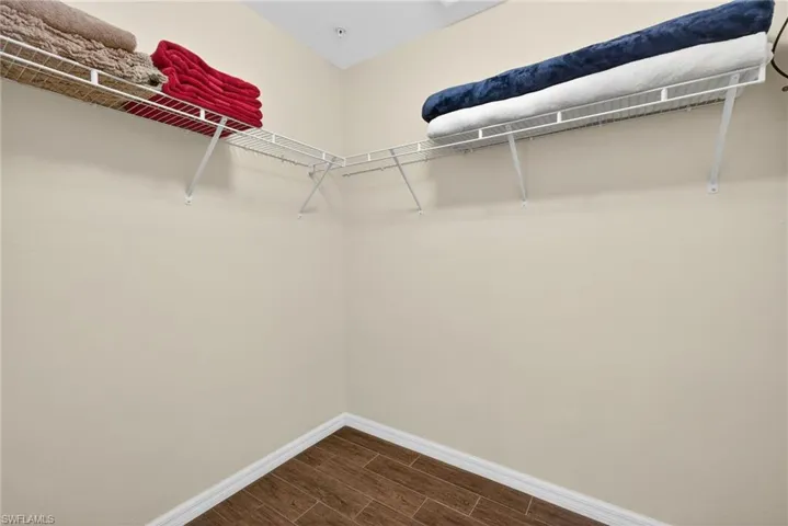 Walk in closet featuring wood finish floors