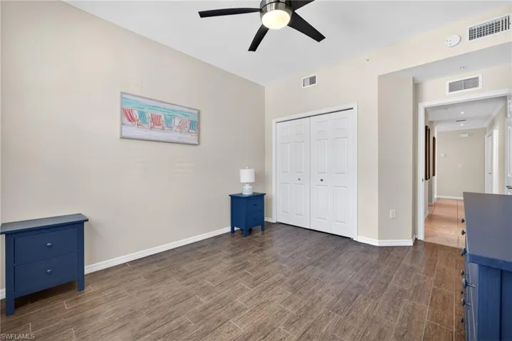 Unfurnished bedroom with wood tiled floors, a closet, and ceiling fan