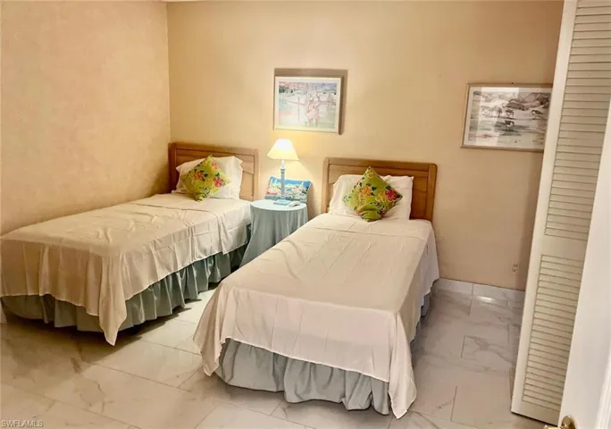 Bedroom with marble-like tile flooring