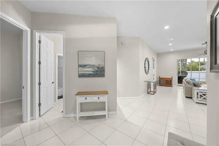 The property features light-colored tile flooring throughout the main areas, providing a bright and cohesive aesthetic