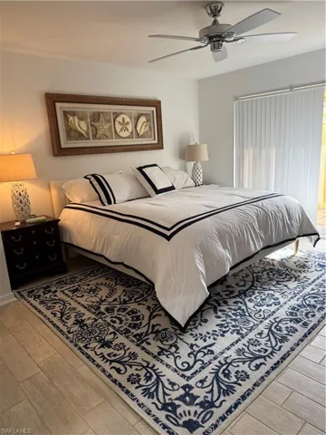 Master Bedroom with wood tiled floors and ceiling fan