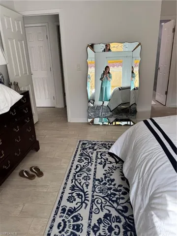 Bedroom with wood tiled floors and baseboards