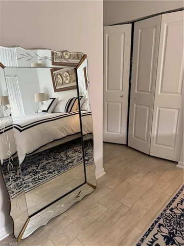 Bedroom with wood finish floors and a closet