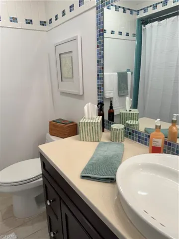 Full bathroom with vanity and a shower with curtain