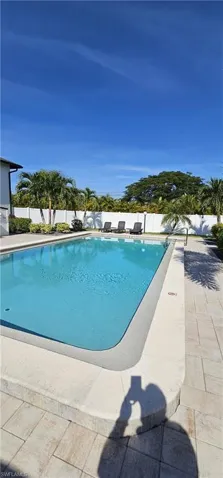 View of pool with a fenced backyard and a patio