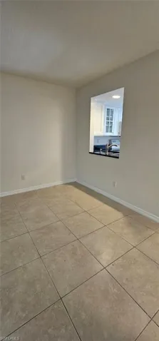Dining room with light tile patterned flooring