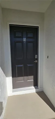 View of exterior entry featuring stucco siding