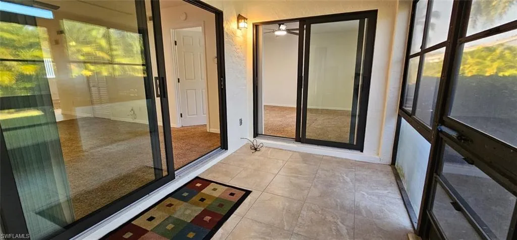 Unfurnished sunroom featuring tile patterned flooring