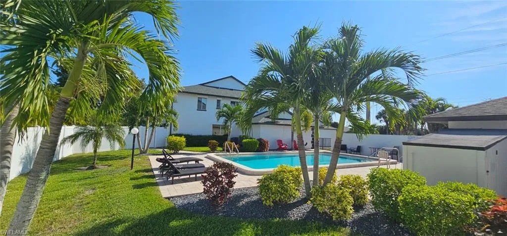 View of swimming pool with a fenced backyard and a patio