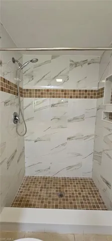 Full bathroom featuring a shower stall
