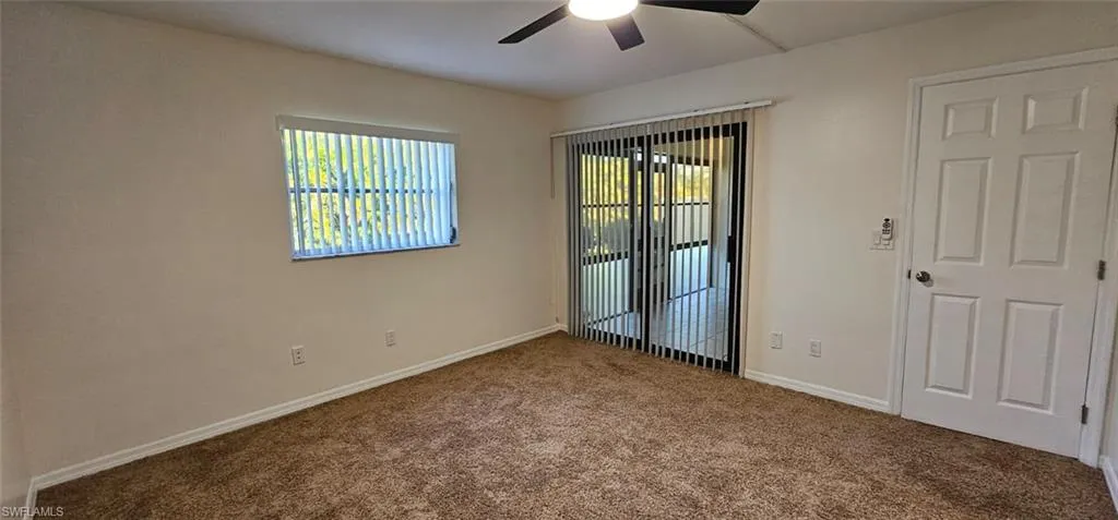 Empty room with carpet floors and ceiling fan