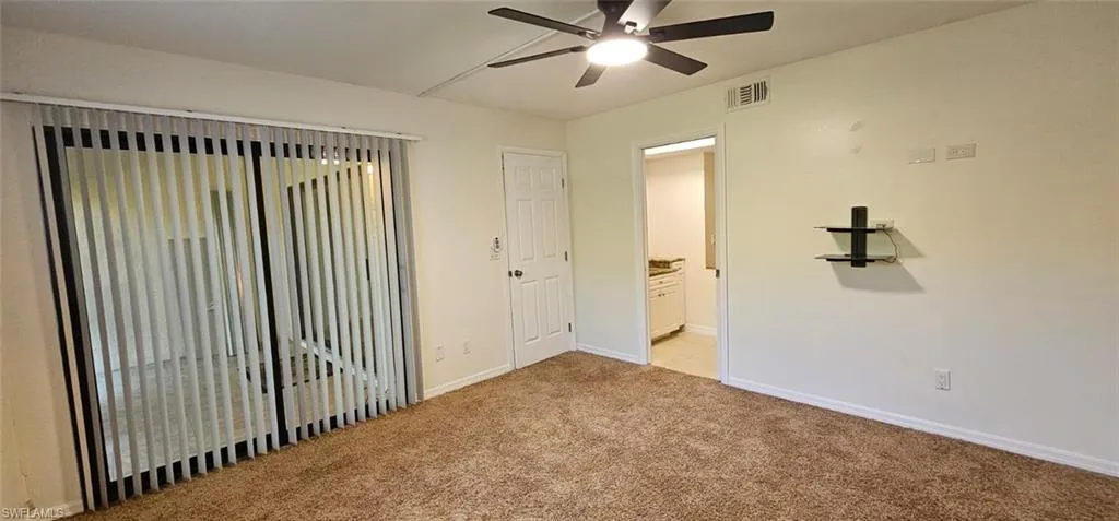 Spare room with light carpet and ceiling fan