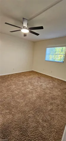 Carpeted Guest room featuring baseboards