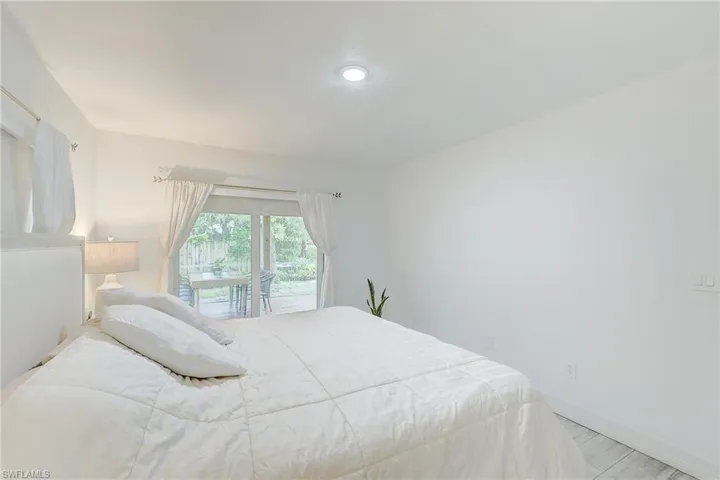 Bedroom featuring access to outside and baseboards