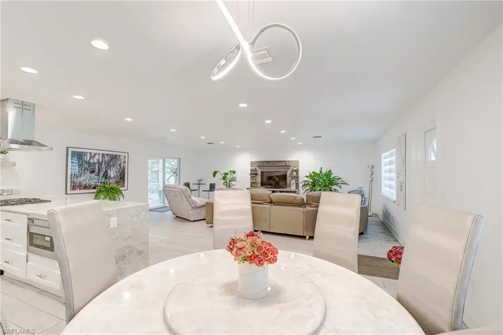 Dining space featuring recessed lighting and light tile patterned flooring