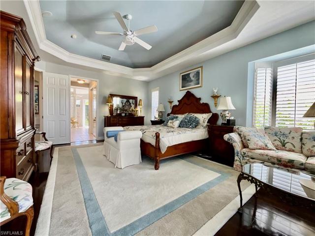Voluminous Owners Suite is privately situated on one side of the home. It features huge walk-in his and hers closets. Enjoy views of the lanai, pool, golf course and lakes.