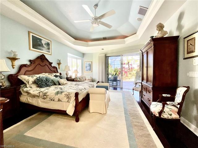 Voluminous Owners Suite is privately situated on one side of the home. It features huge walk-in his and hers closets. Enjoy views of the lanai, pool, golf course and lakes.