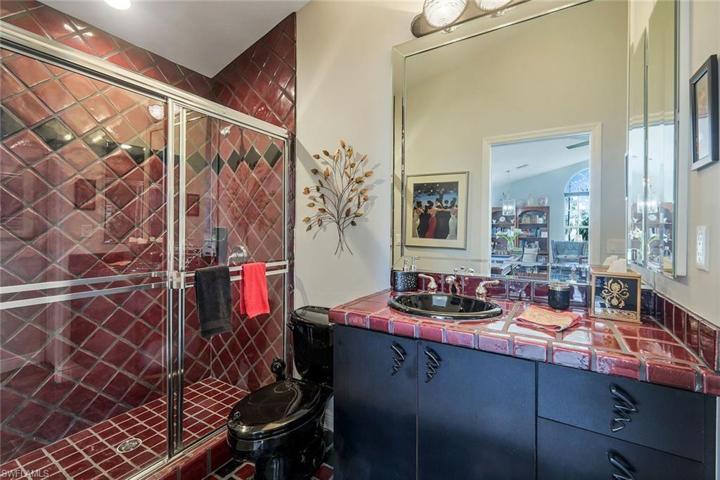3-car garage with epoxy finish, numerous built in cabinets, wine storage and refrigerator