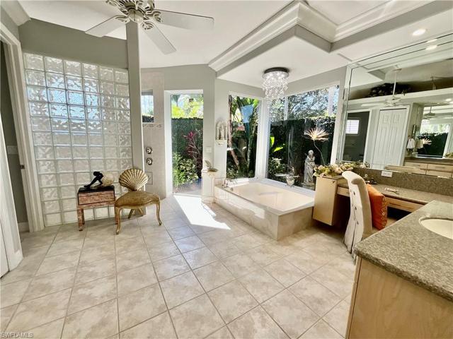 Owners Suite features an oversized bathroom with a walk-in multiple head shower large enough for 2 people.  Soaking tub overlooks a private walled courtyard.  His and hers vanities, a water and linen closet.