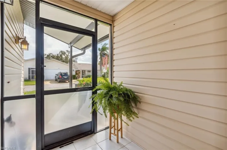 Doorway with light tile patterned floors