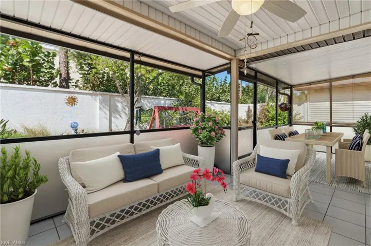 Virtually staged Sunroom / solarium featuring a ceiling fan, outdoor dining space, and an outdoor living space