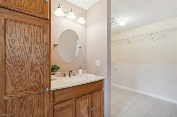 Bathroom featuring vanity and a textured ceiling