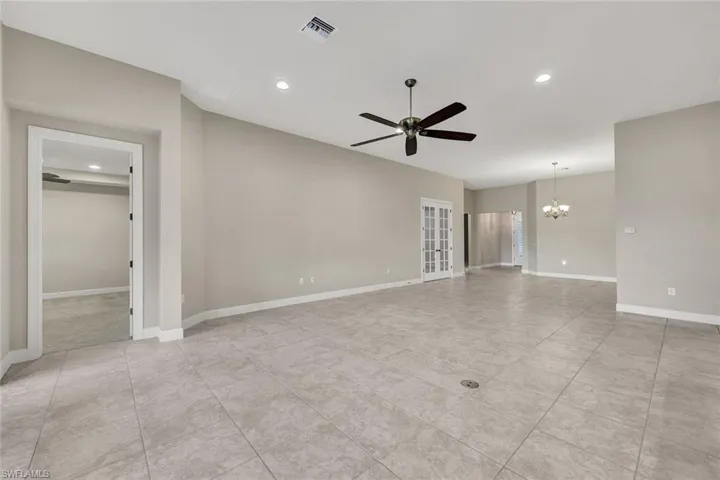 Primary bedroom overlooking beautiful lake and French doors leading to the den!
