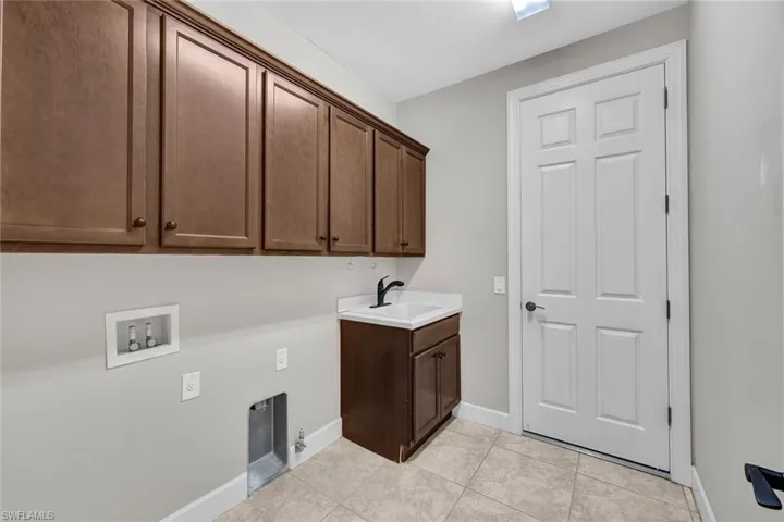Utility room with great upper cabinet storage and sink!