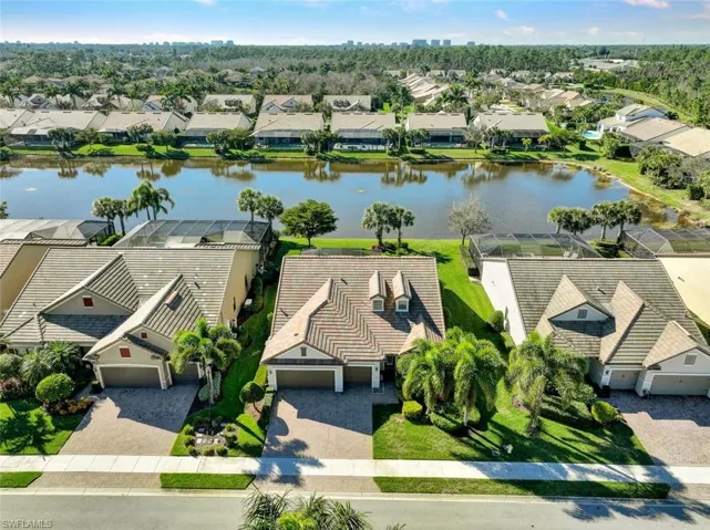 Birds eye view of property with a water view