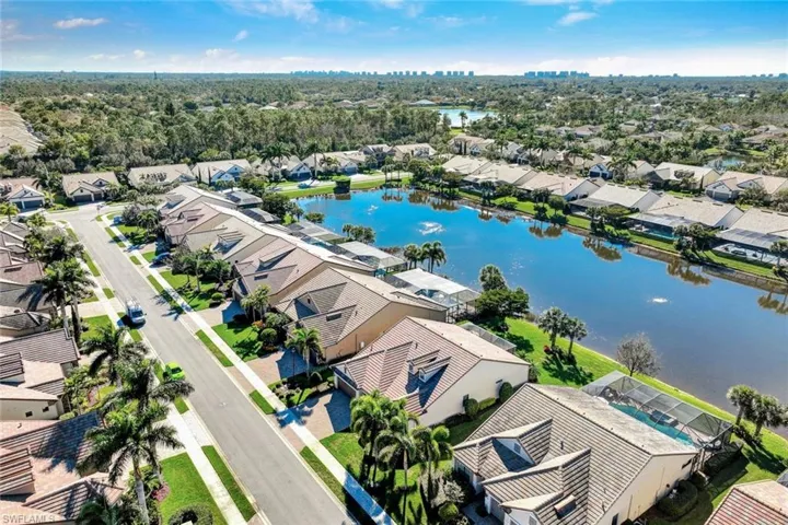 Birds eye view of property with a water view