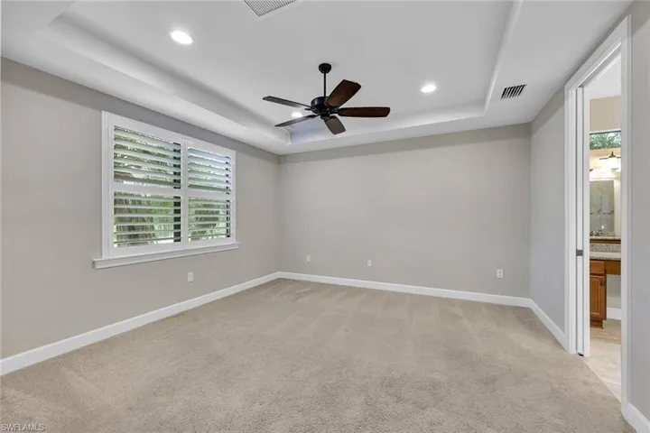 Primary bedroom with tray ceiling and recessed lights!