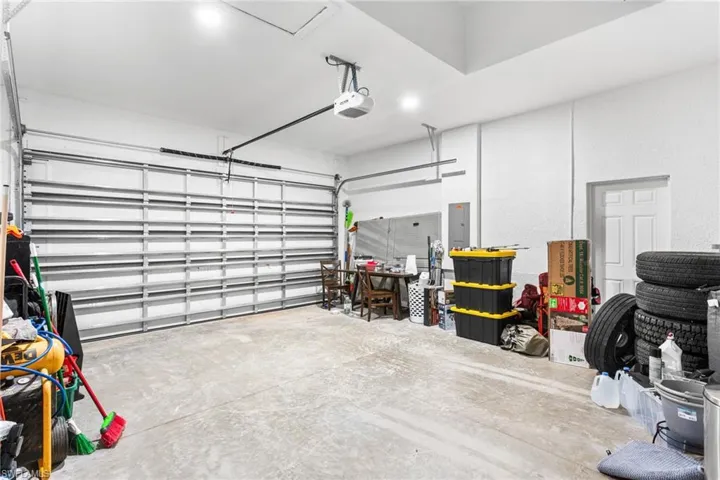 Garage with electric panel and a garage door opener