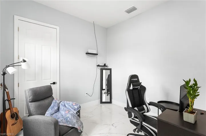 Office with light marble finish flooring and baseboards