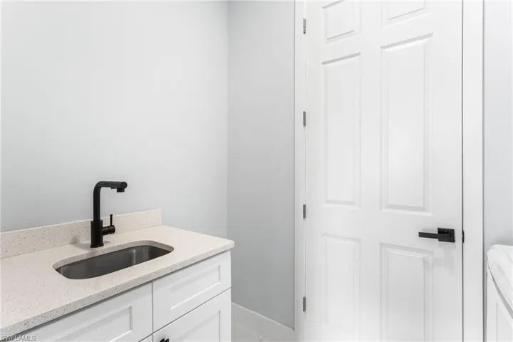 Bathroom with vanity and baseboards